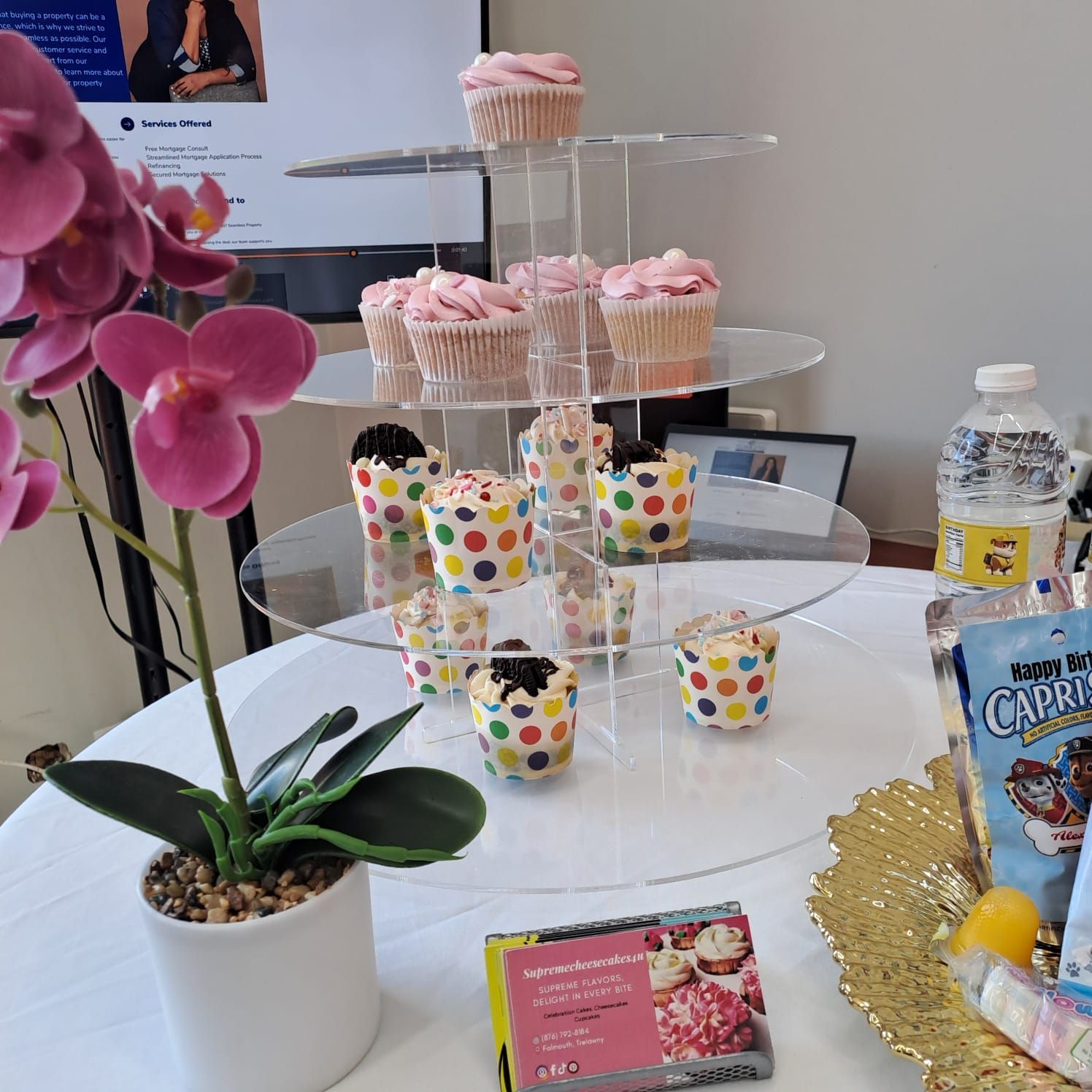A table topped with cupcakes and a box of capri sun