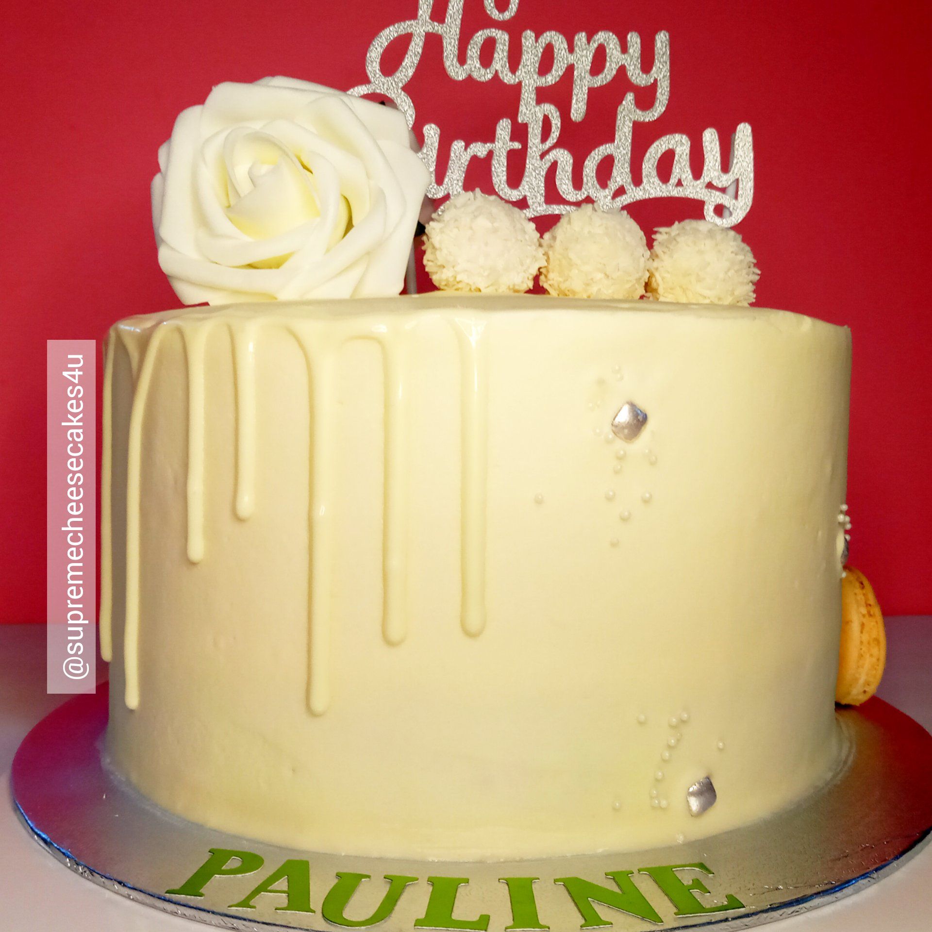 A white birthday cake with the name pauline on it