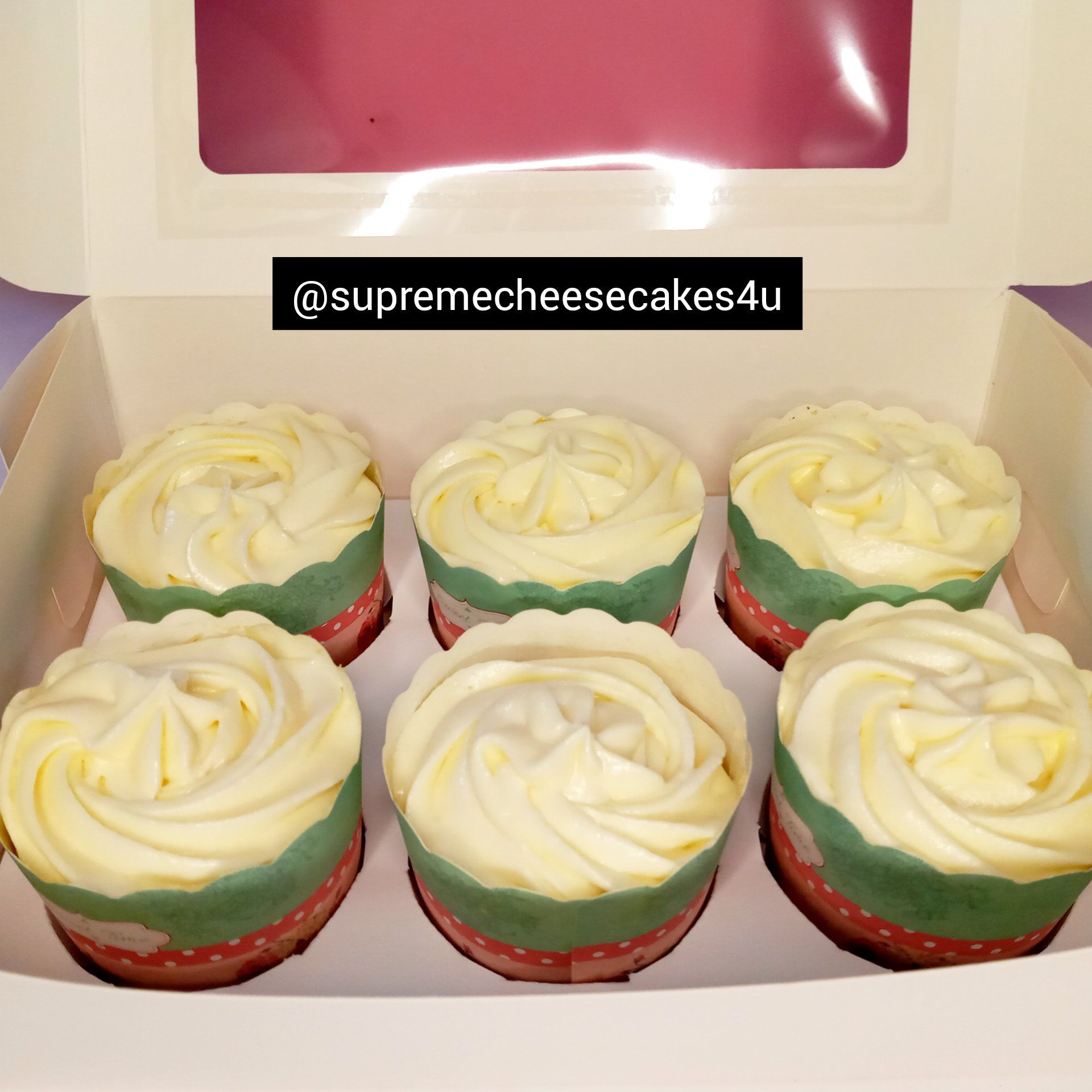 Six cupcakes in a box with a label that says supreme cheesecakes4u