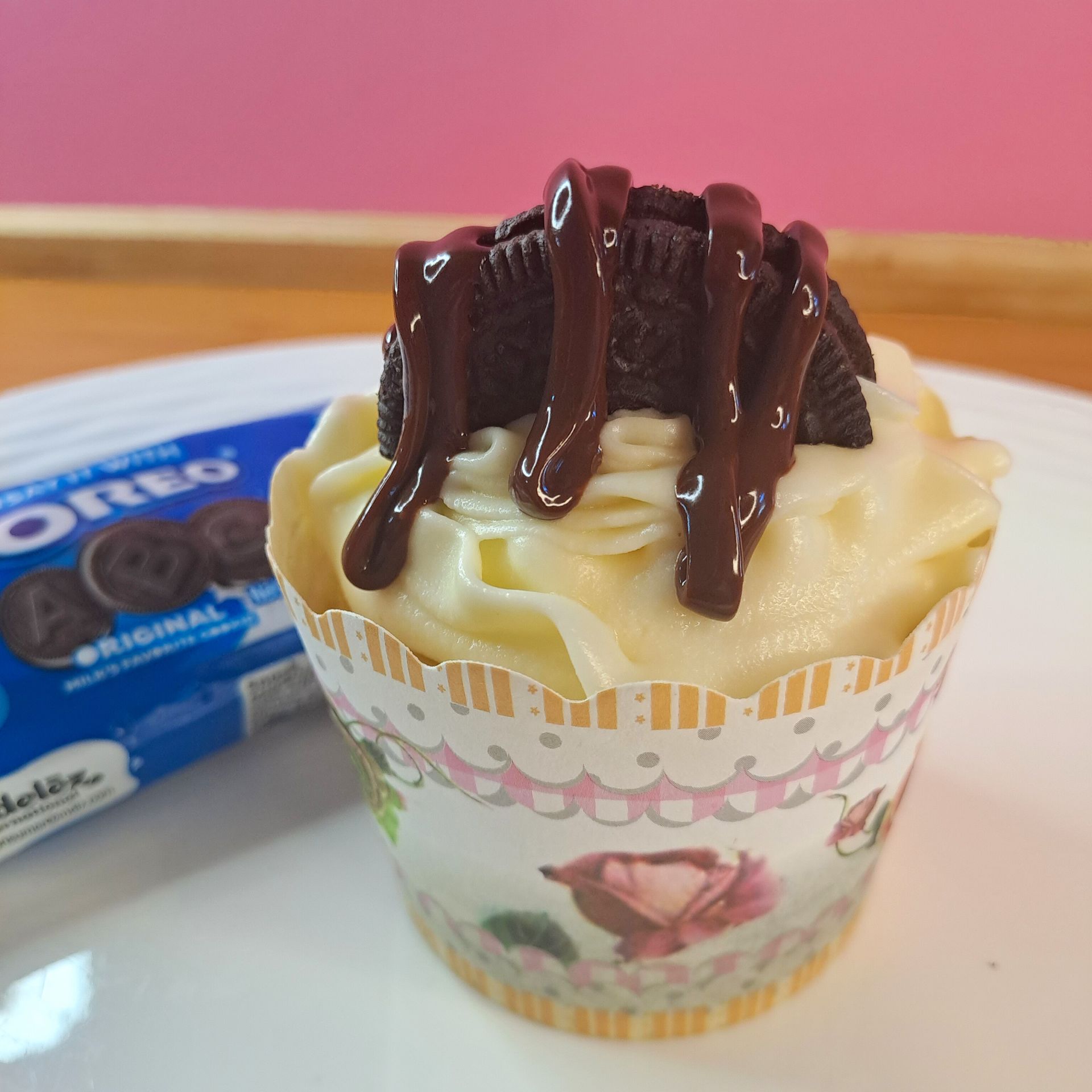 A cupcake with oreos on top of it on a plate