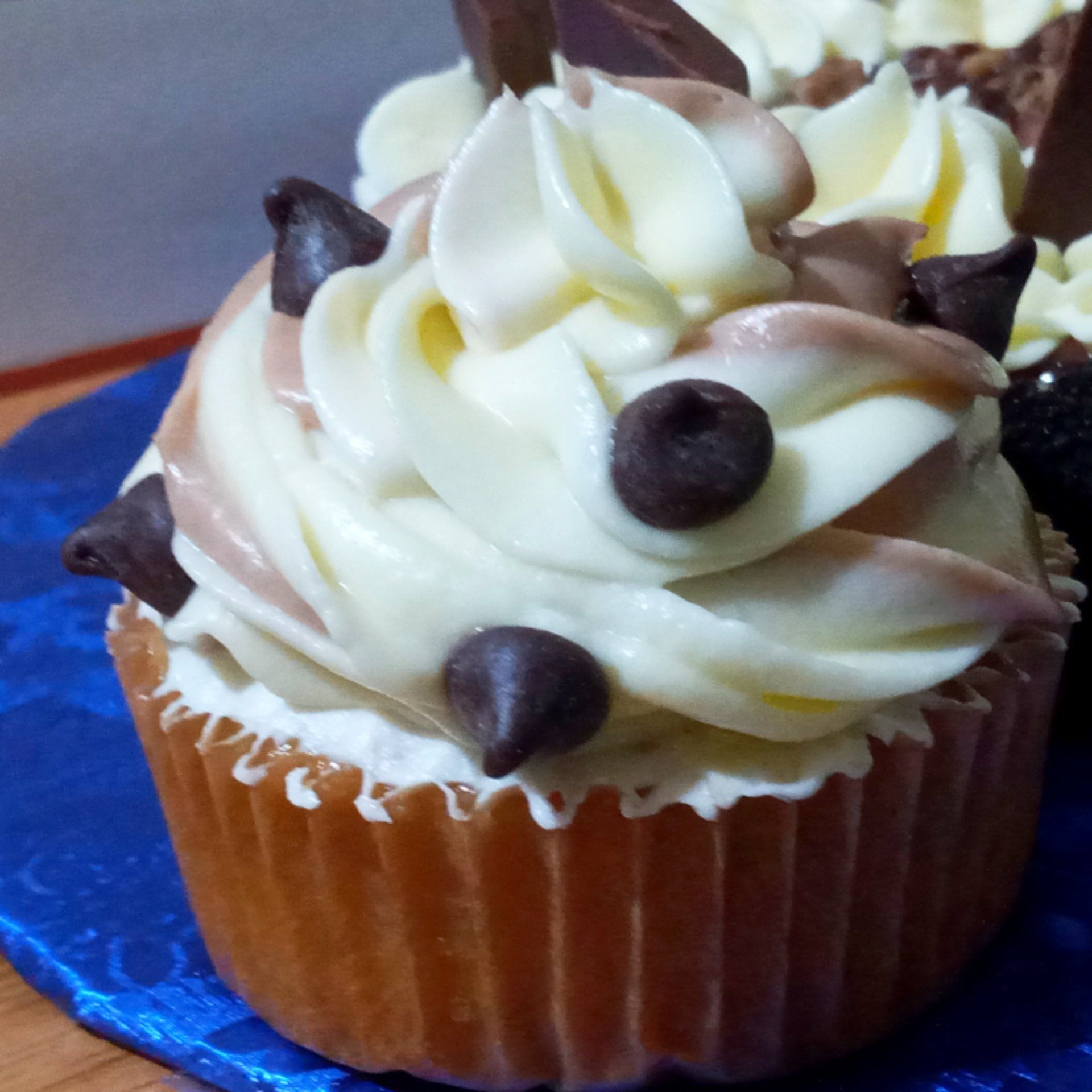 A close up of a cupcake with chocolate chips on top