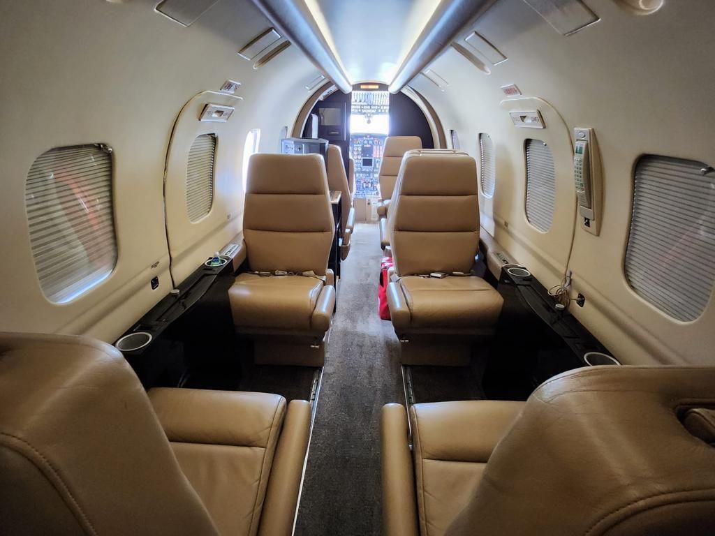 The inside of a private jet with a lot of seats