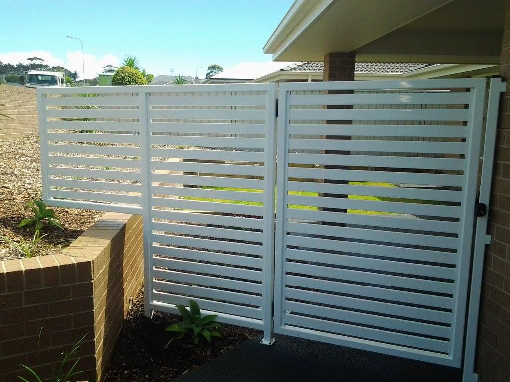 A White Fence With a Gate in Front of a House — Riverside Aluminium & Stainless in Harrington, NSW