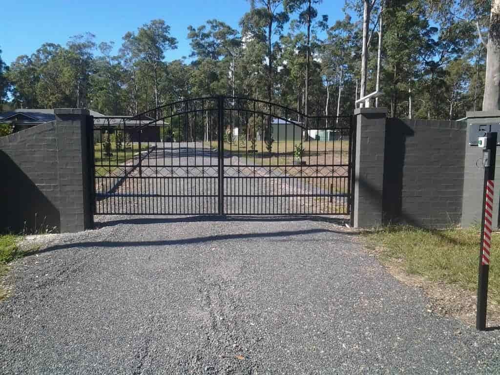 A Metal Gate is Open to a Gravel Road — Riverside Aluminium & Stainless in Gloucester, NSW