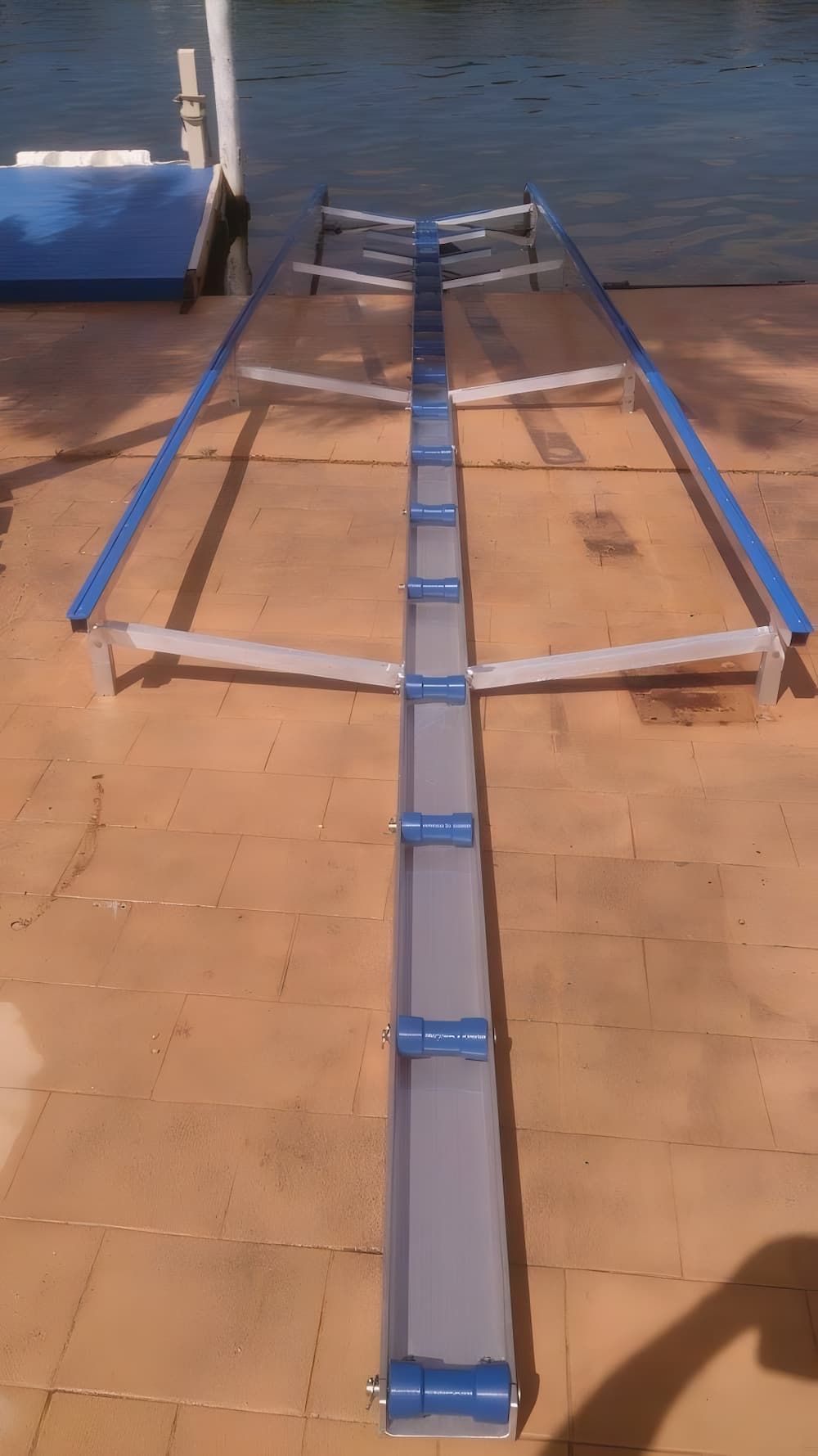 A Slipway is Sitting on a Dock Next to a Body of Water — Riverside Aluminium & Stainless in Forster, NSW