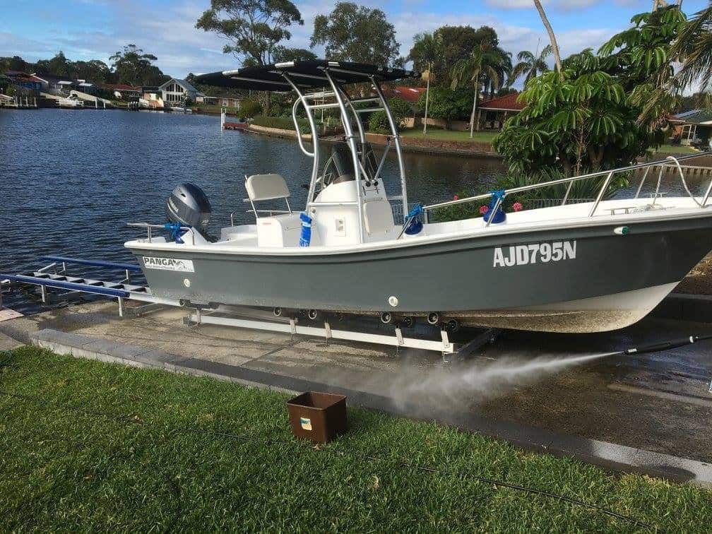 A Boat is Sitting on a Dock Next to a Body of Water — Riverside Aluminium & Stainless in Coolongolook, NSW