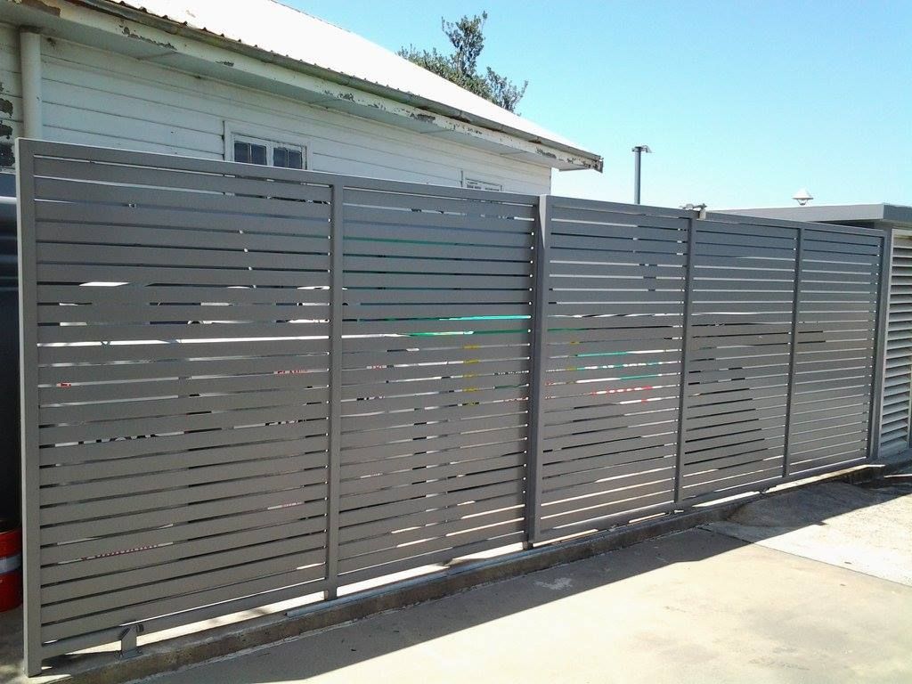 A Fence is Sitting in Front of a House on a Sunny Day — Riverside Aluminium & Stainless in Coolongolook, NSW