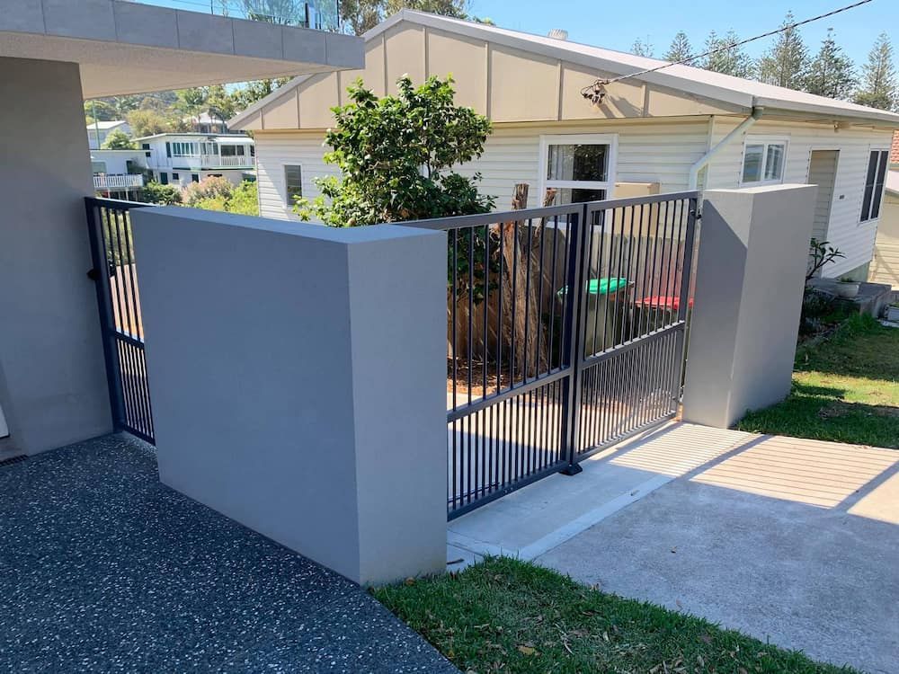 A House With a Fence and a Gate in Front of It — Riverside Aluminium & Stainless in Forster, NSW