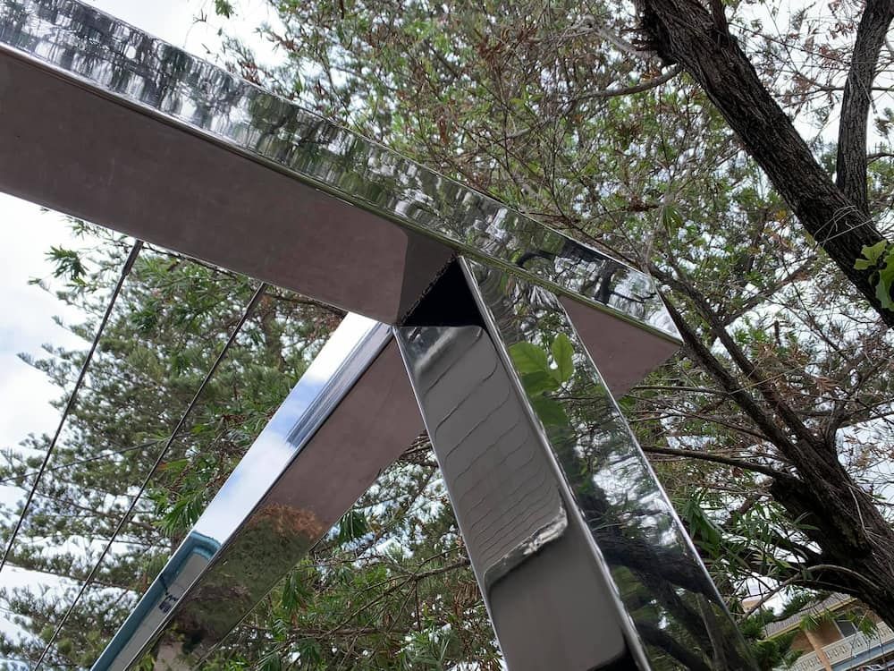 Looking up at a metal structure with trees in the background — Riverside Aluminium & Stainless in Gloucester, NSW