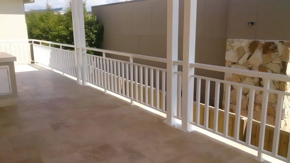 A Balcony With a White Railing and a Tiled Floor  — Riverside Aluminium & Stainless in Taree, NSW