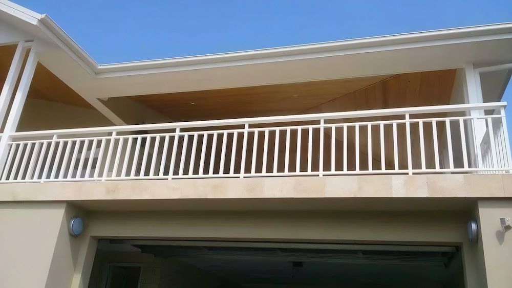 A Balcony With a White Railing on the Side of a House  — Riverside Aluminium & Stainless in Taree, NSW