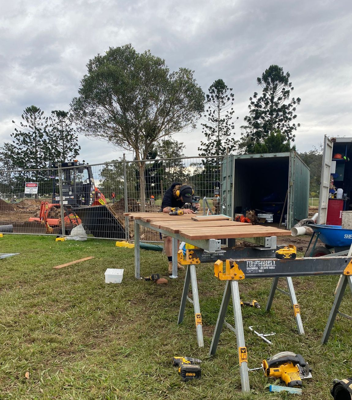 Man cutting and measuring wooden slats  — North Coast Building & Maintenance in Lismore, NSW