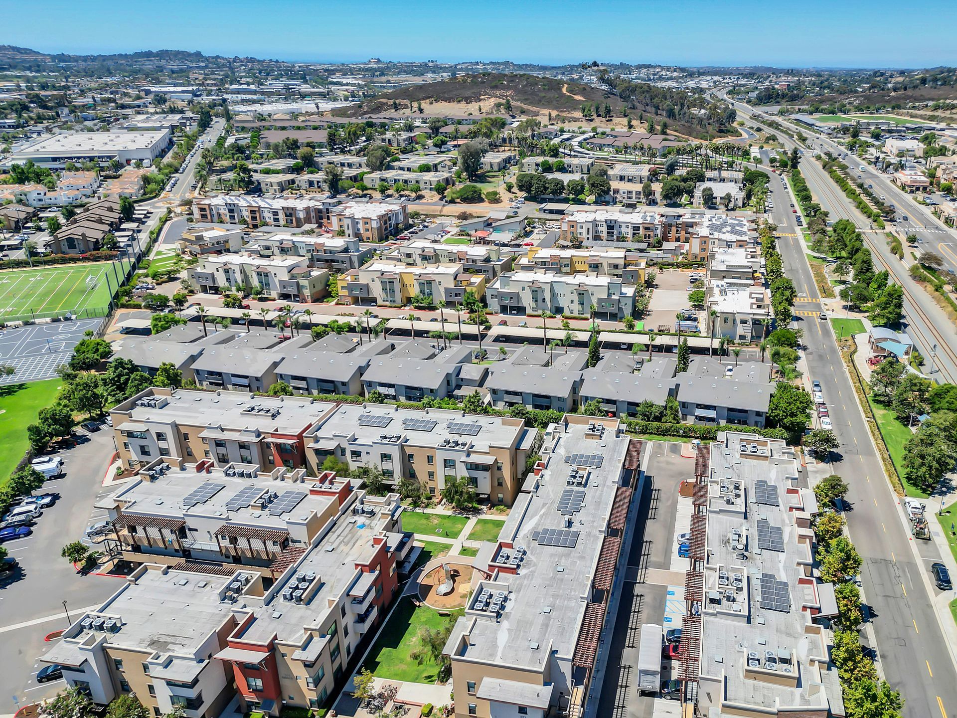 An aerial view of a residential area with lots of buildings and trees.