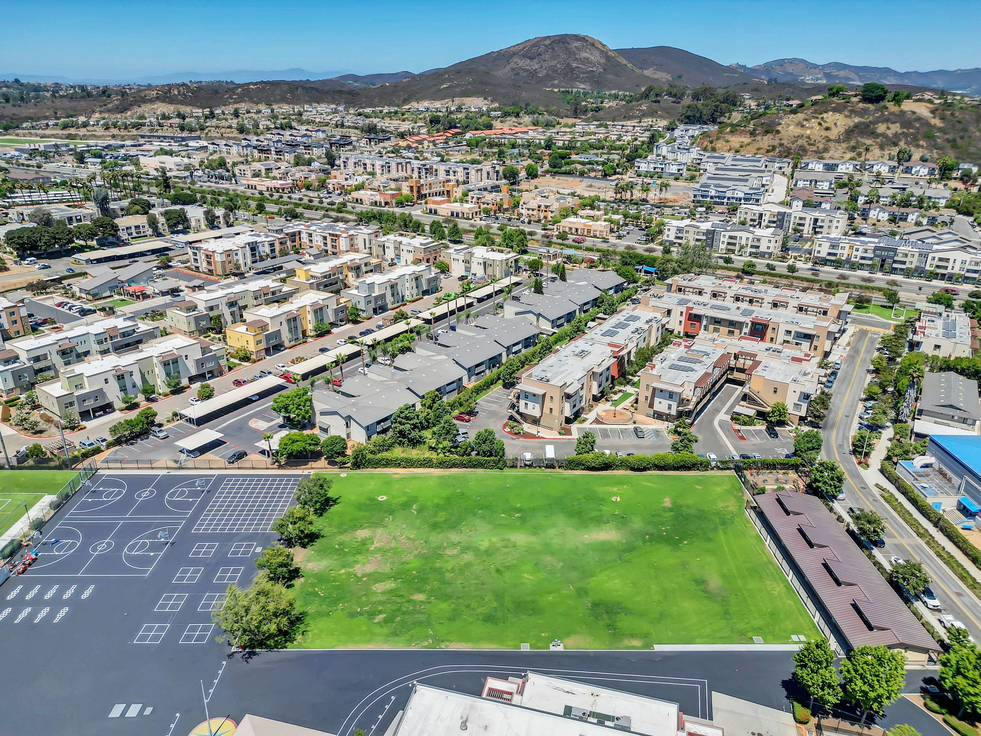 An aerial view of a city with mountains in the background