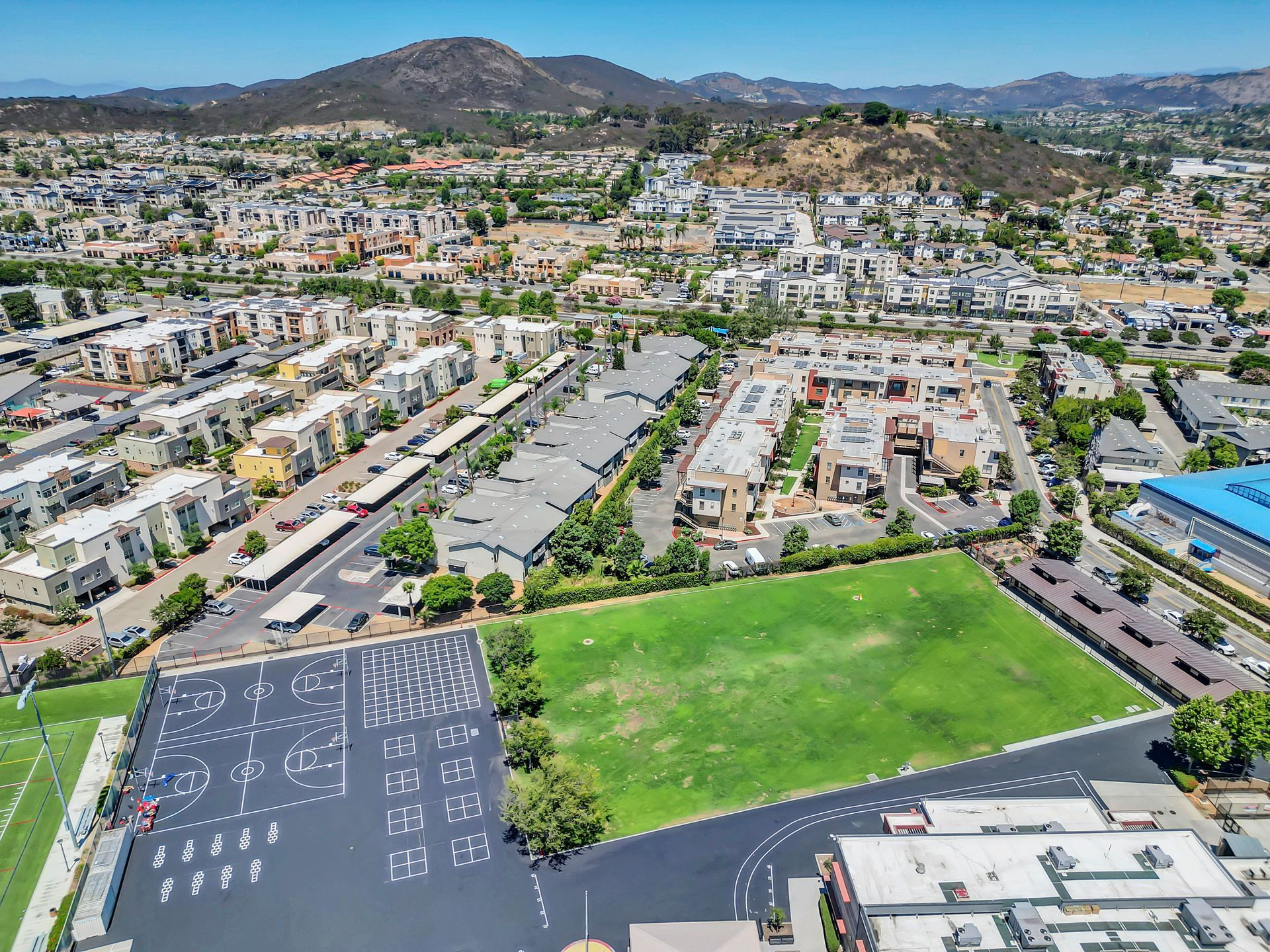 An aerial view of a city with mountains in the background.