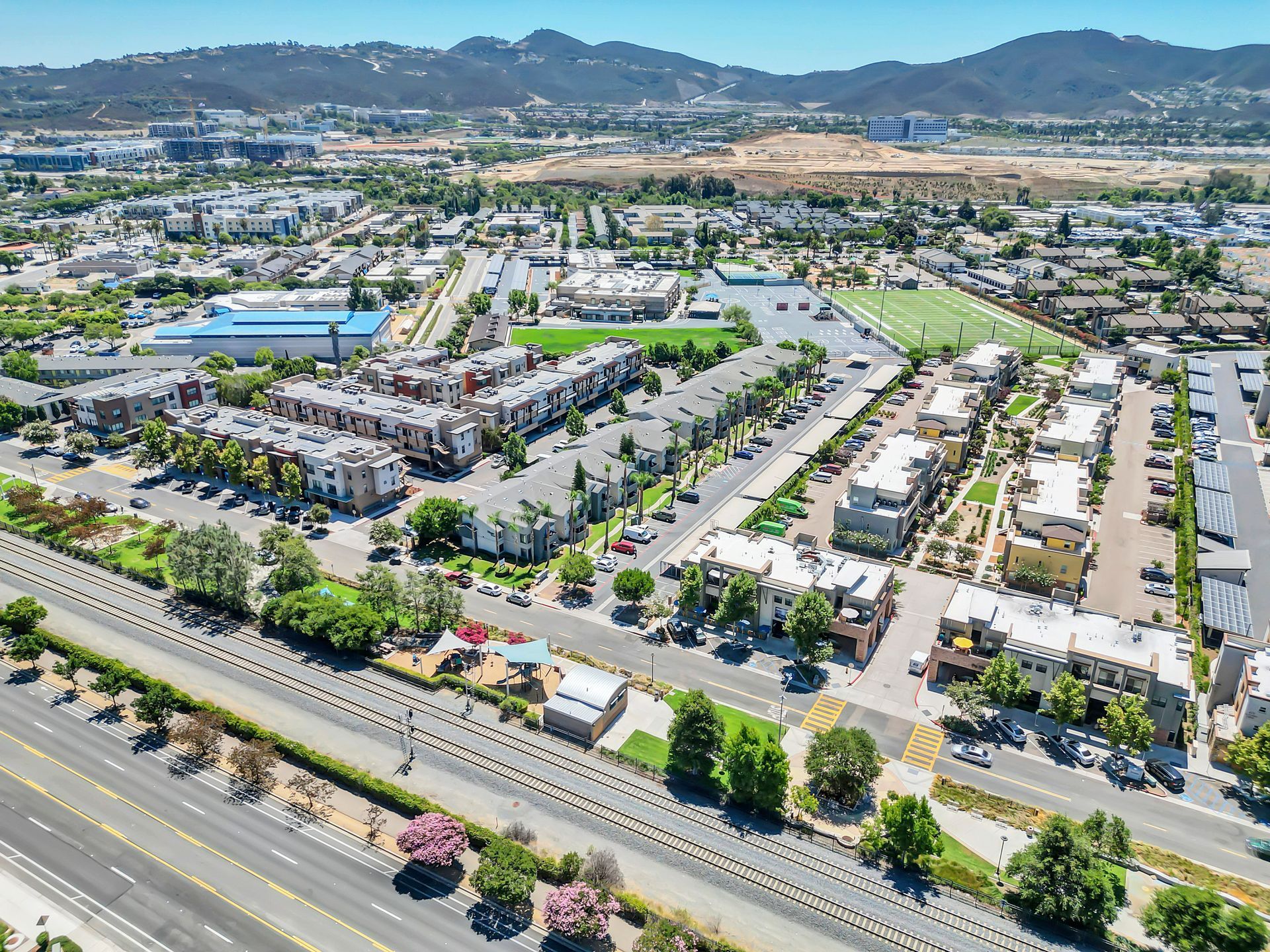 An aerial view of a city with mountains in the background.