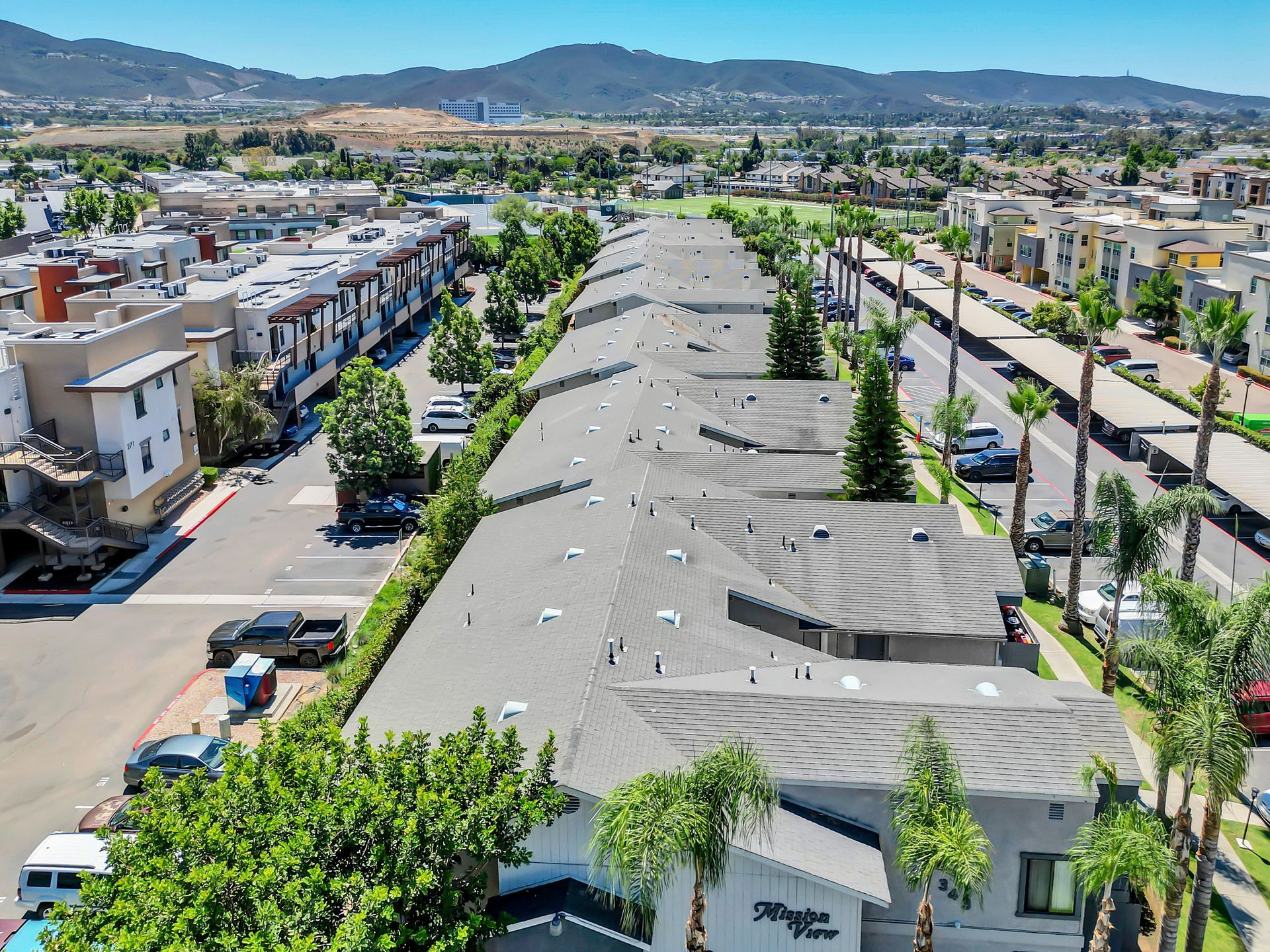 An aerial view of a residential area with lots of buildings and trees