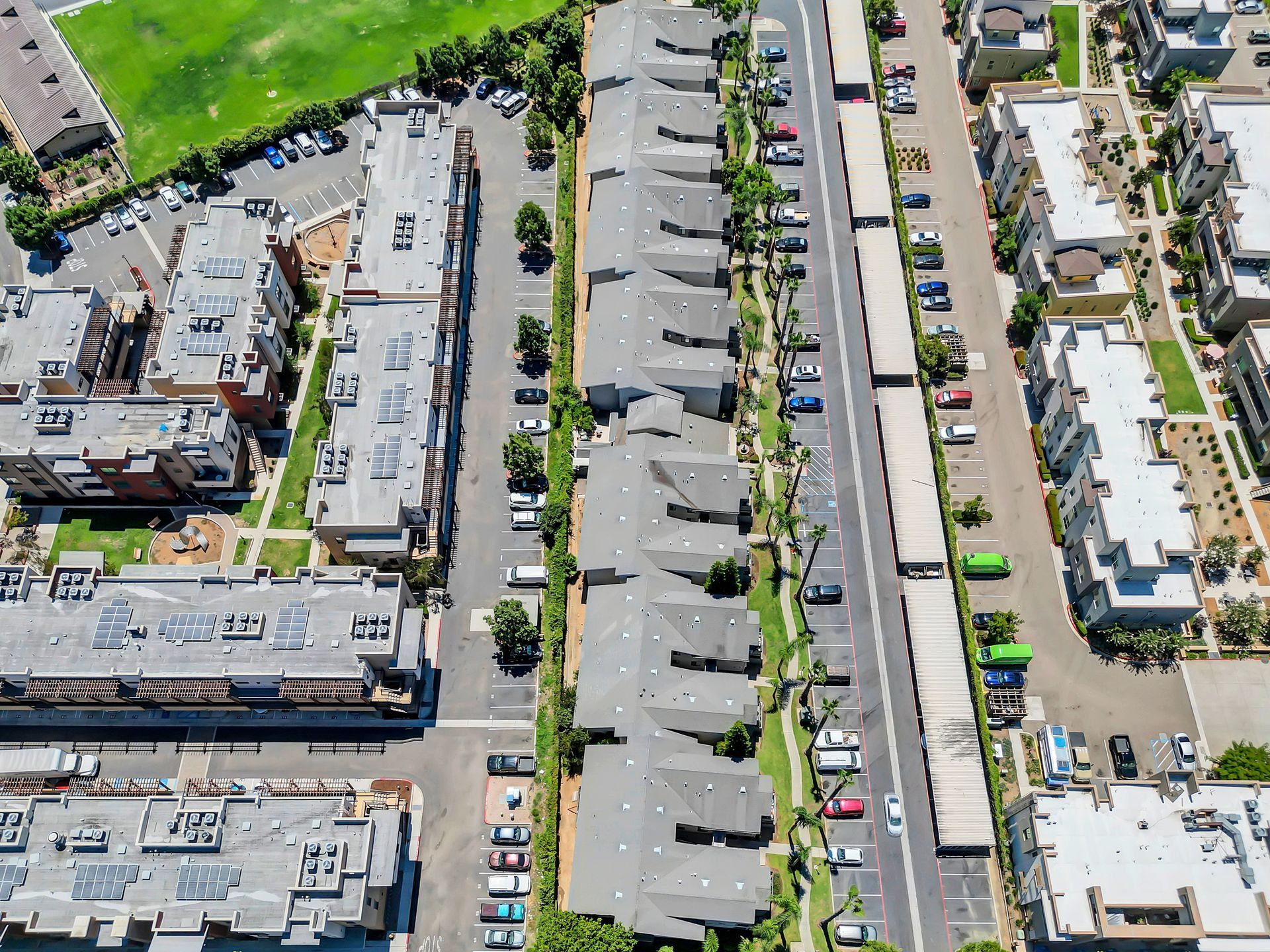 An aerial view of a residential area with lots of buildings and parking lots.