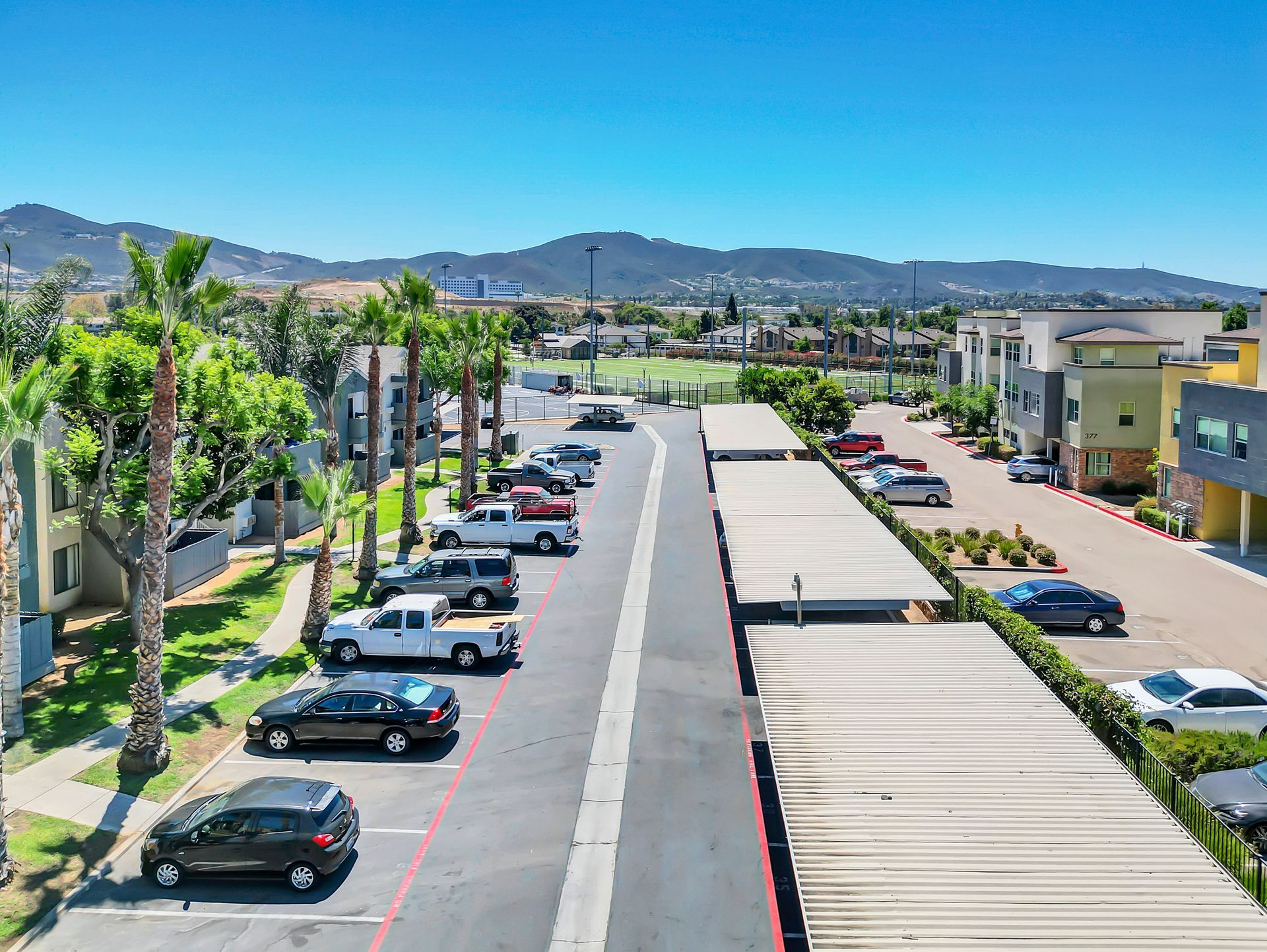 An aerial view of a parking lot with cars parked in it.