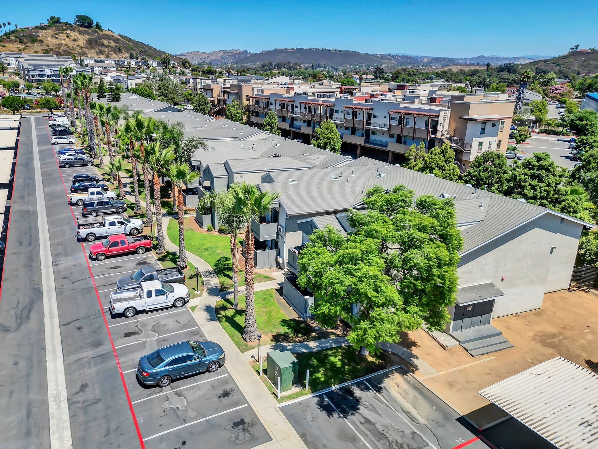 An aerial view of a parking lot in front of a building