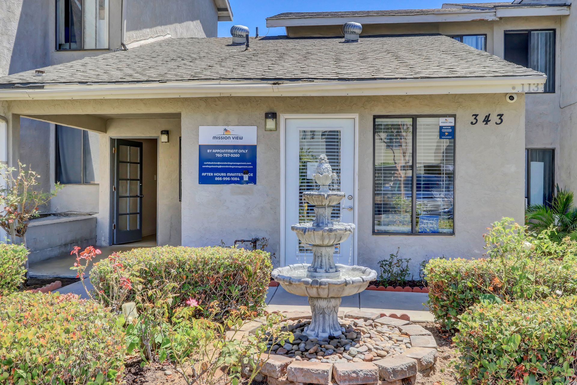 The front of a building with a fountain in front of it