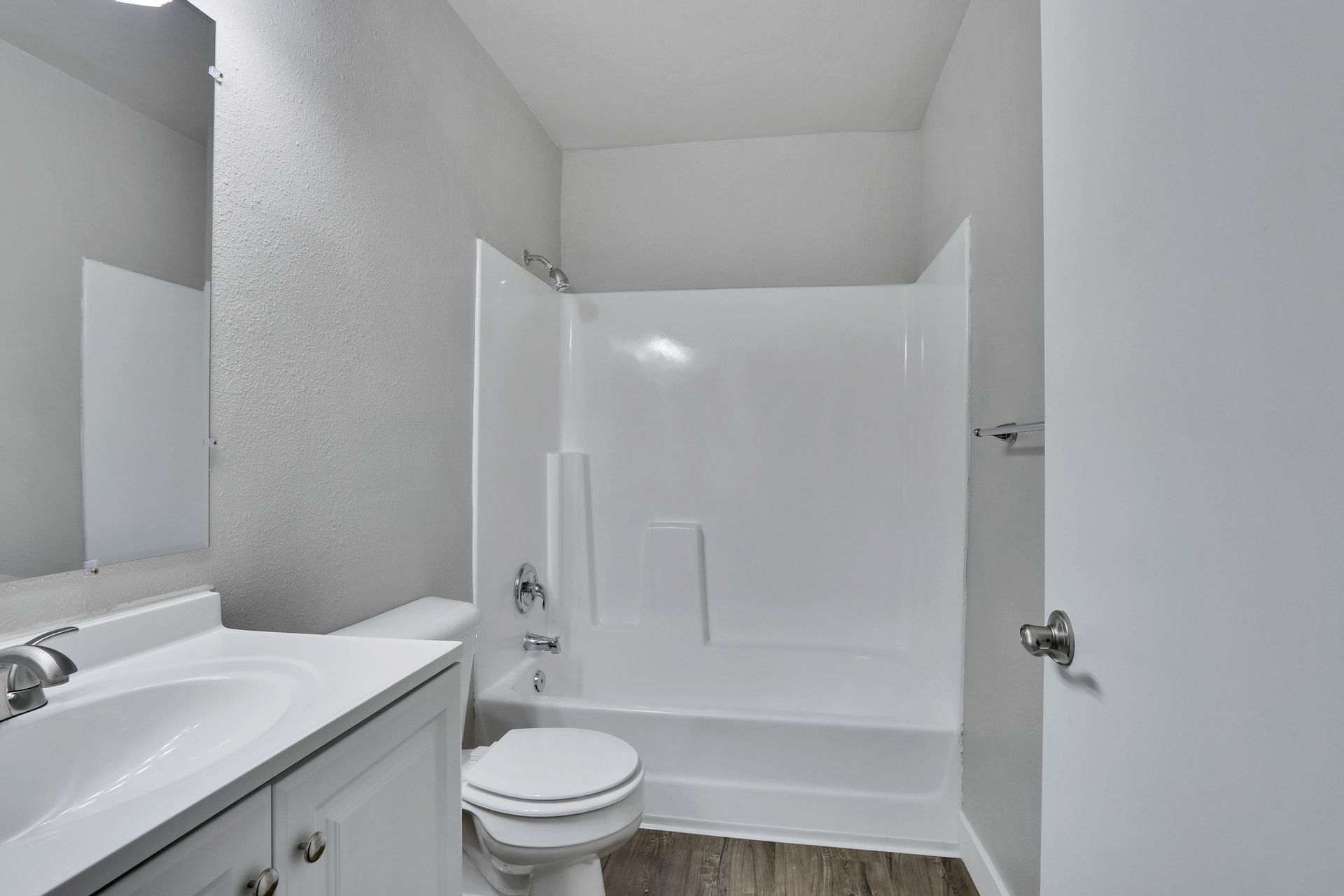 A bathroom with a toilet , sink , and bathtub.