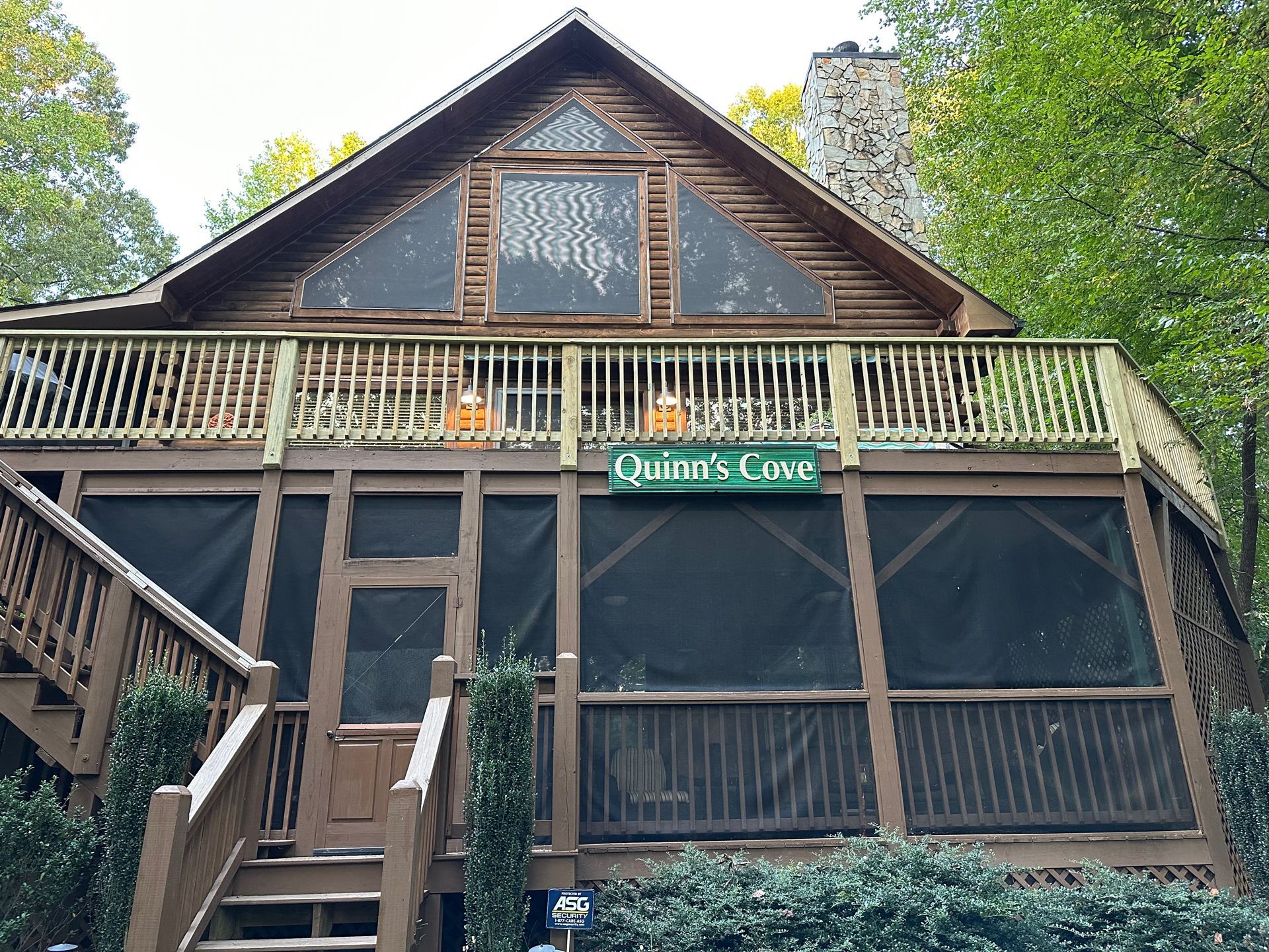 Wooden cabin with porch and screened-in area; 