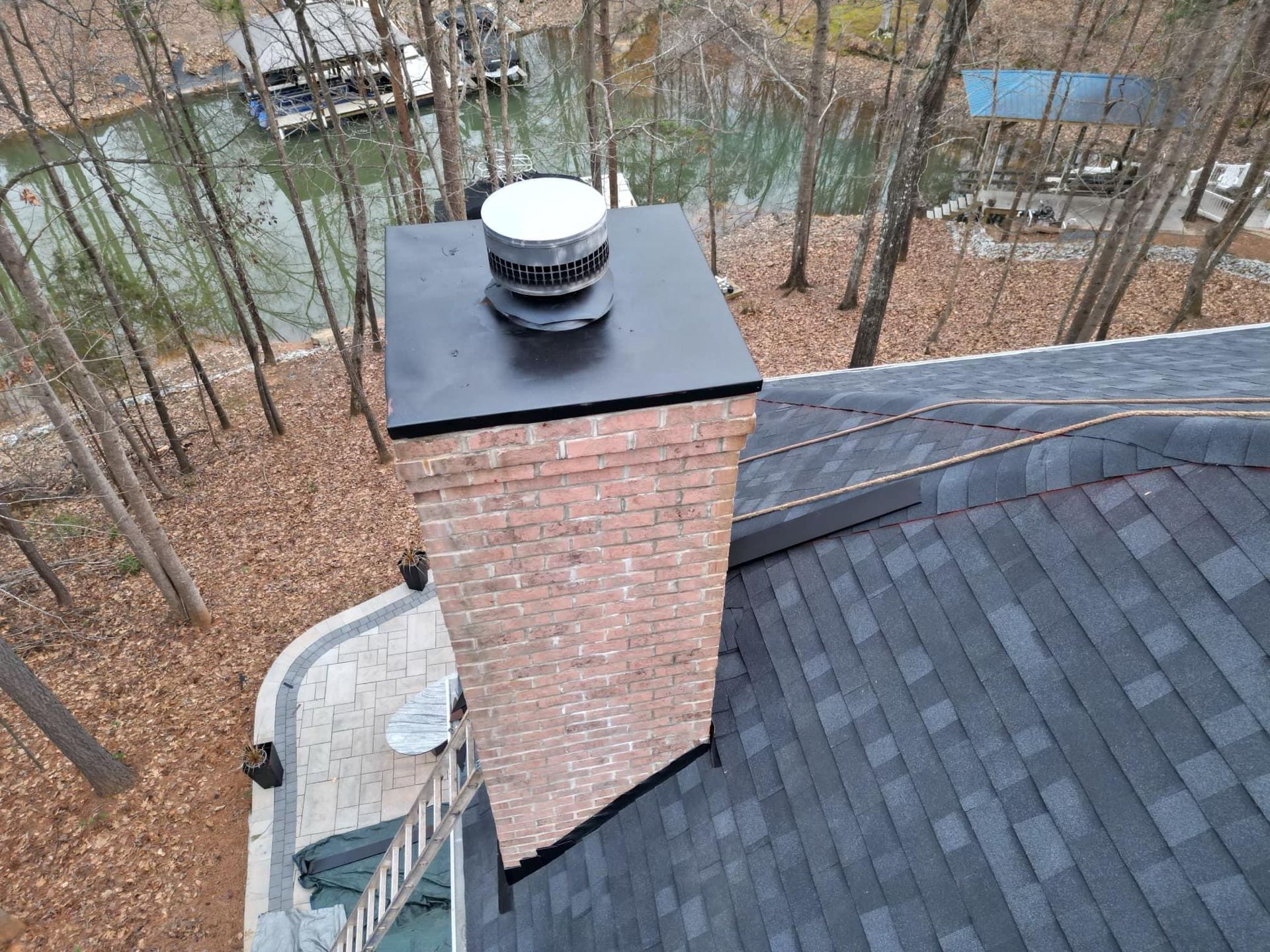 Modern kitchen with white and natural wood cabinets, stainless steel appliances, and a dining area.