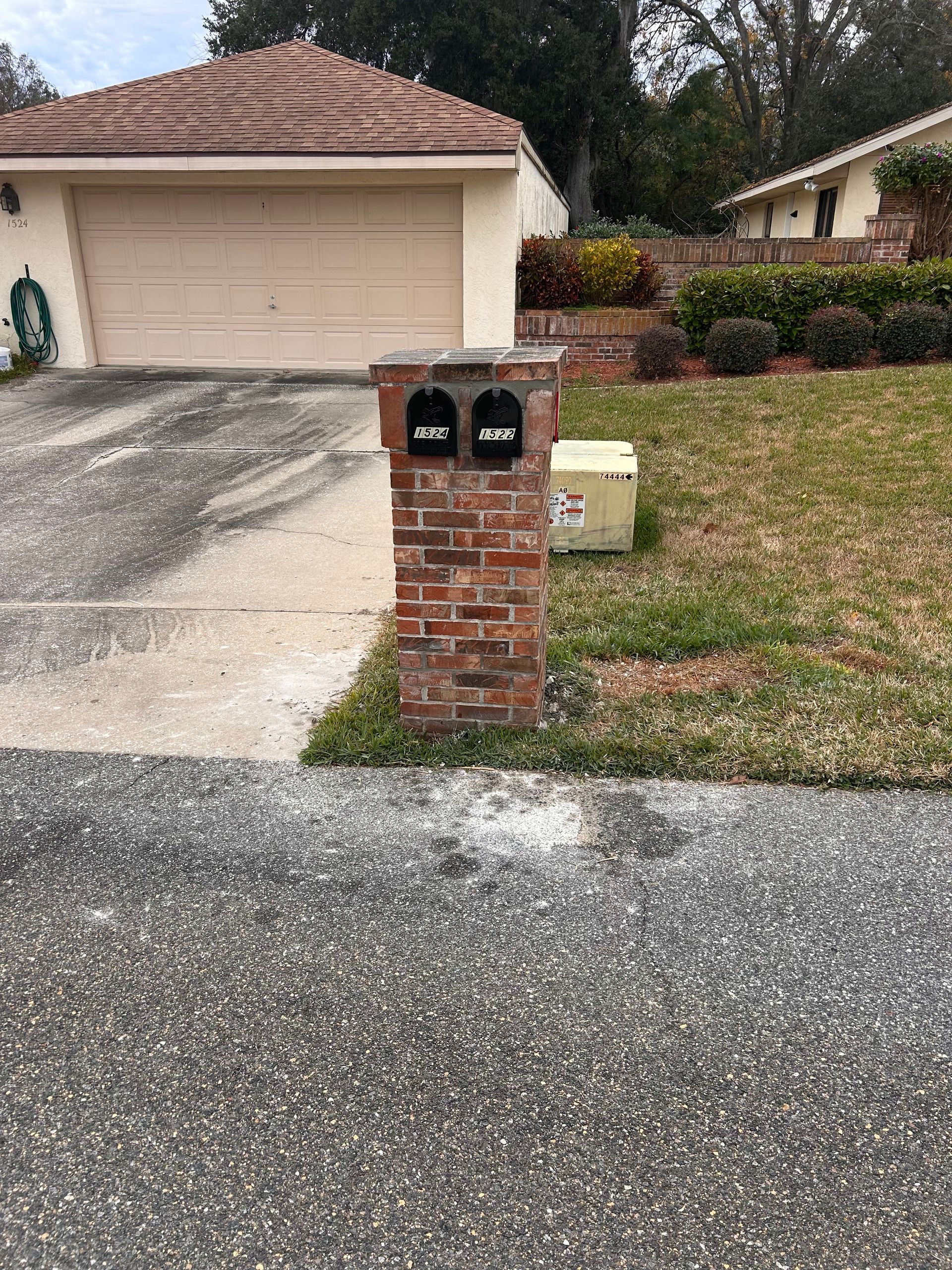 Person patching a wall inside a room with a wooden ceiling and window. Tools and materials are on the floor.