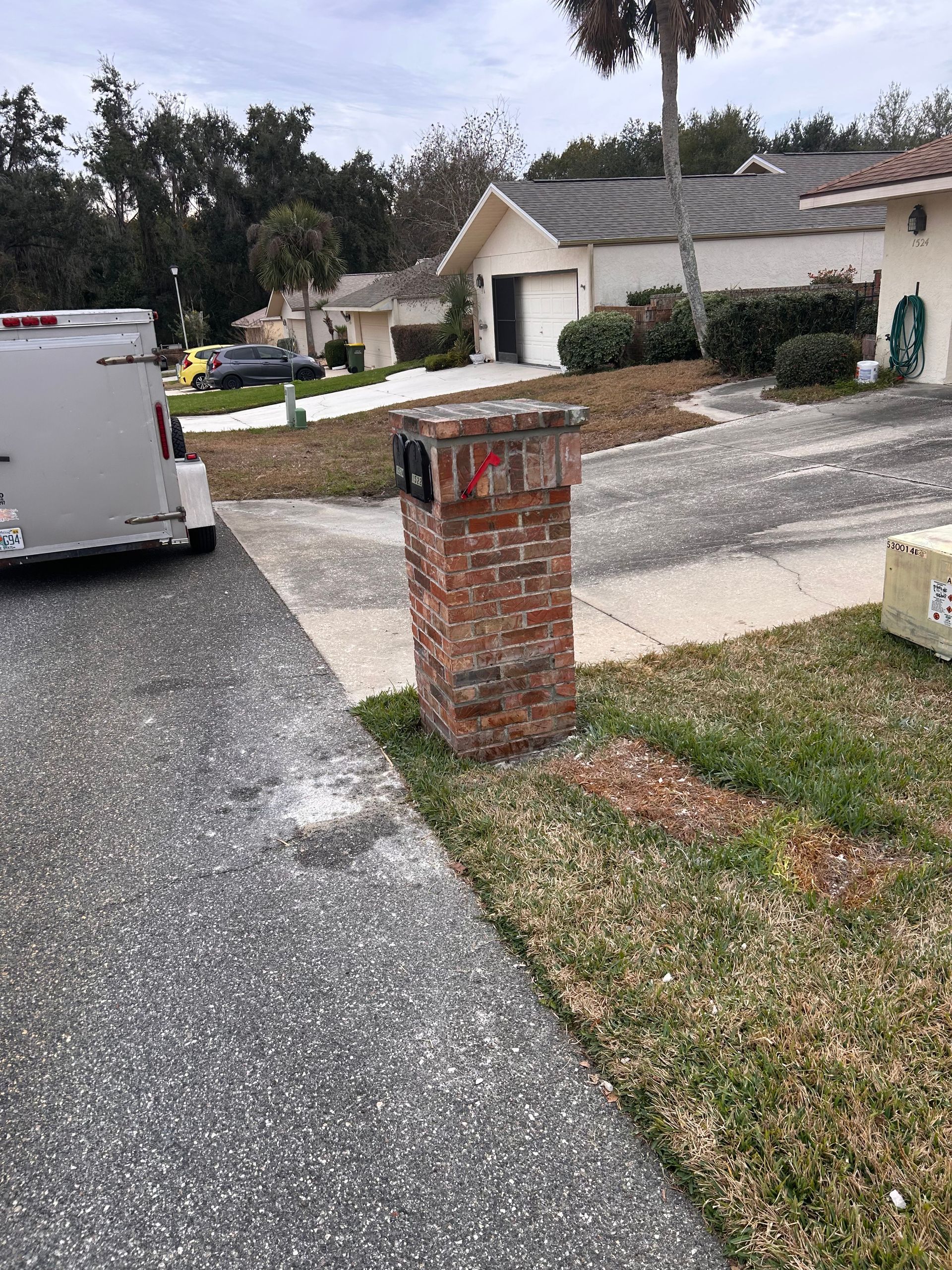 Bedroom with wood flooring, green accent wall, bed, and TV on a table by a window.