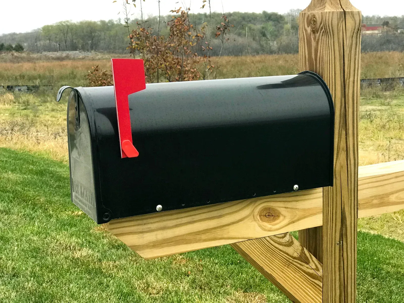 Modern kitchen with white and natural wood cabinets, stainless steel appliances, and a dining area.