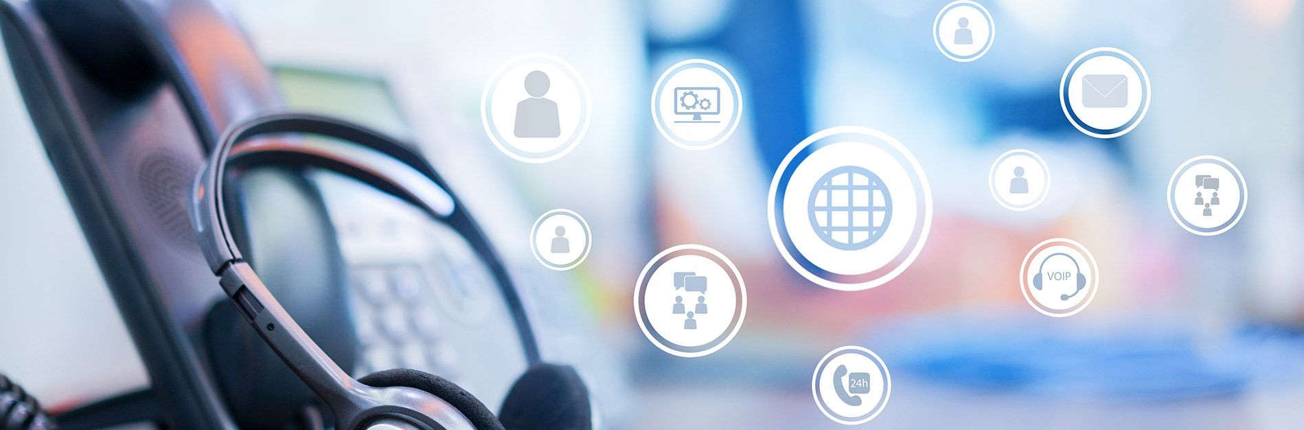 A close up of a headset sitting on top of a computer.