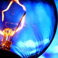 A close up of a light bulb with a blue background