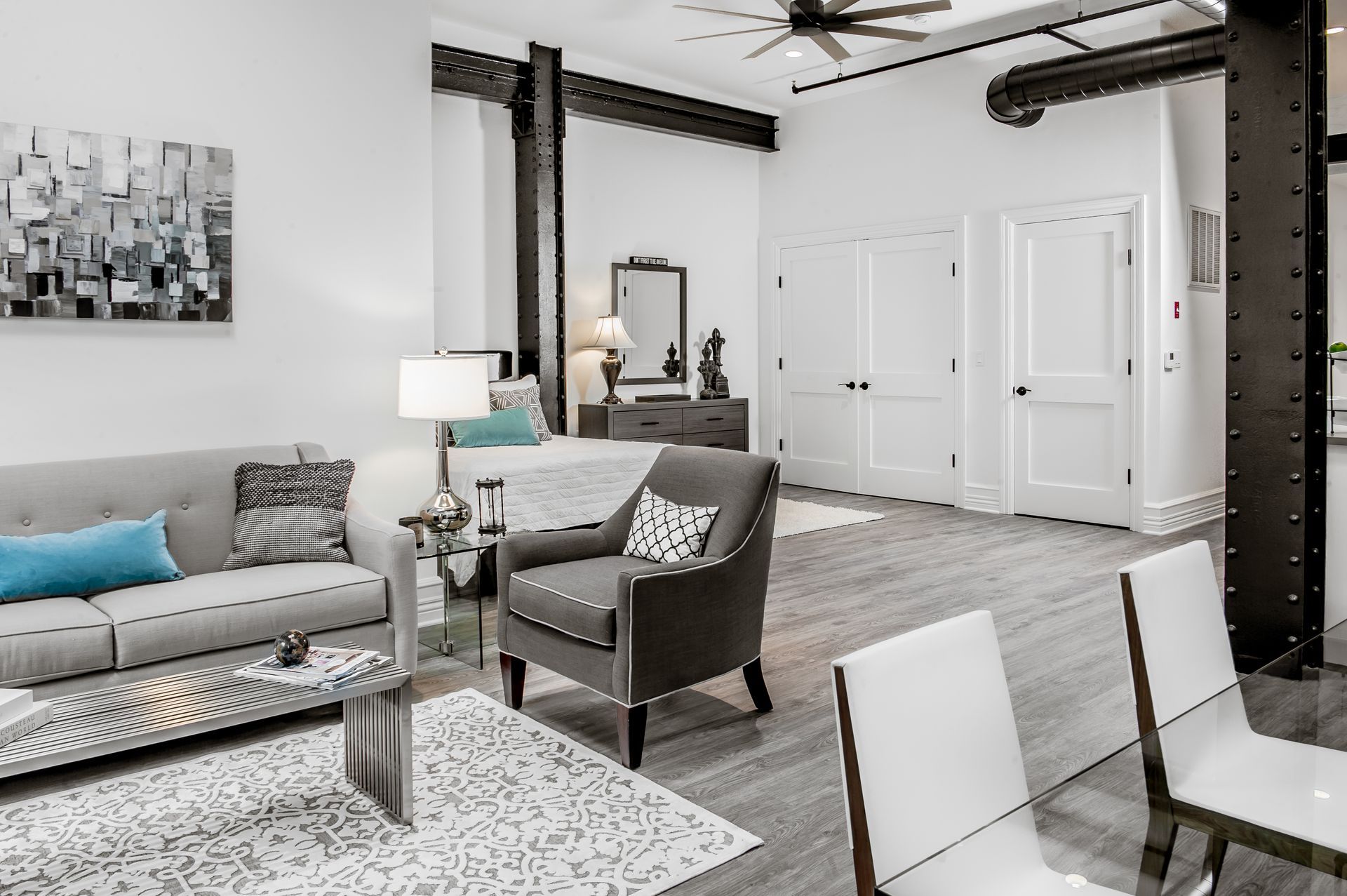 A living room with a couch , chair , table and chairs.