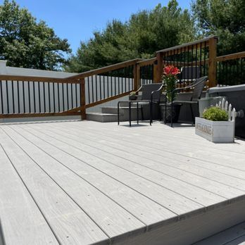 A wooden deck with chairs and a sign that says welcome