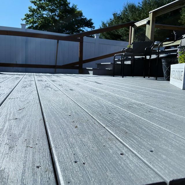 A wooden deck with a welcome sign on it