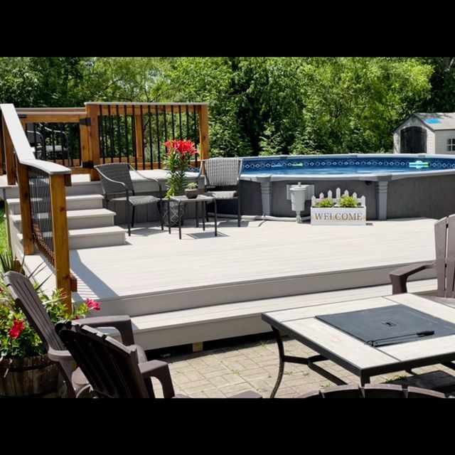 A deck with a table and chairs and a sign that says welcome