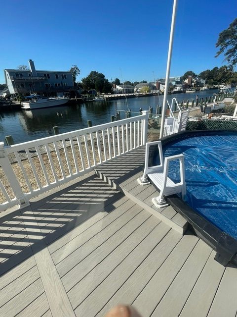 A close up of a white wooden deck with steps.