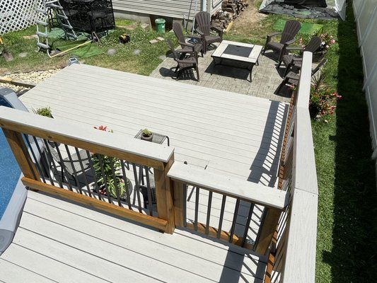 An aerial view of a deck with chairs and a fire pit.
