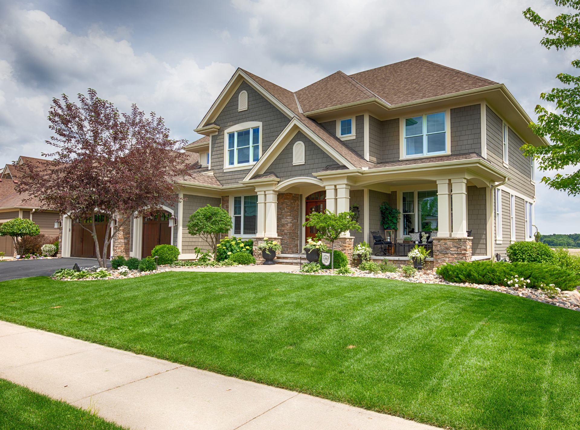 A large house with a lush green lawn in front of it.