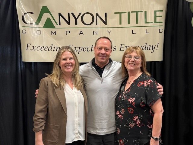 Canyon Title team members Candice Heideman, Andy Conradson, and Shawn Grimes at the 2026 NOCO REALTOR® Summit booth in Loveland, Colorado
