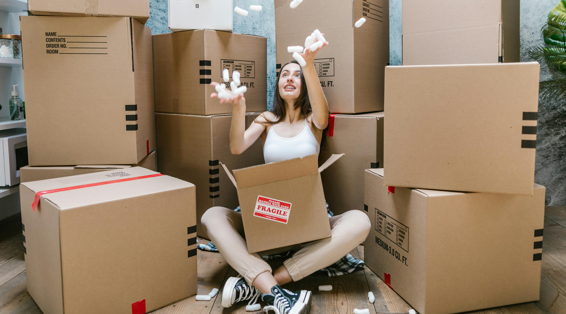 Women catching lights surrounded by boxes