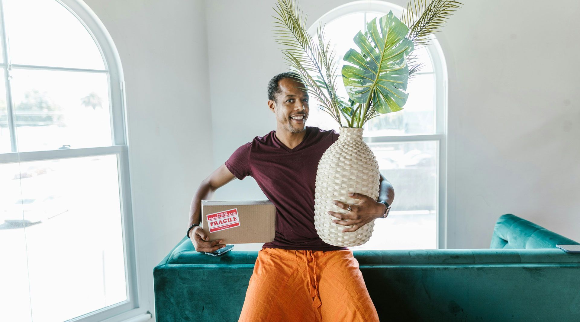 Happy man holding a plant