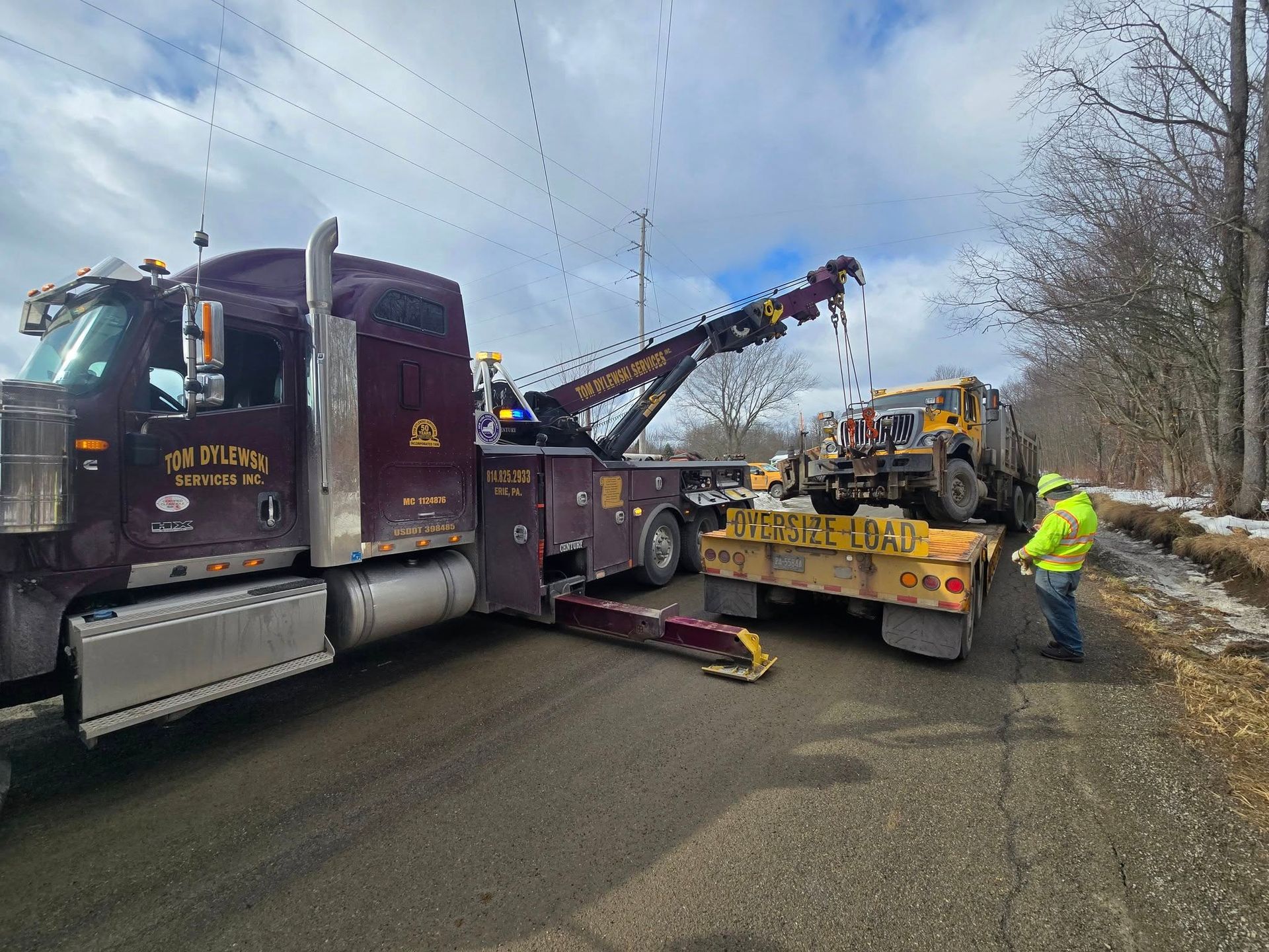 A car is upside down on the side of the road.