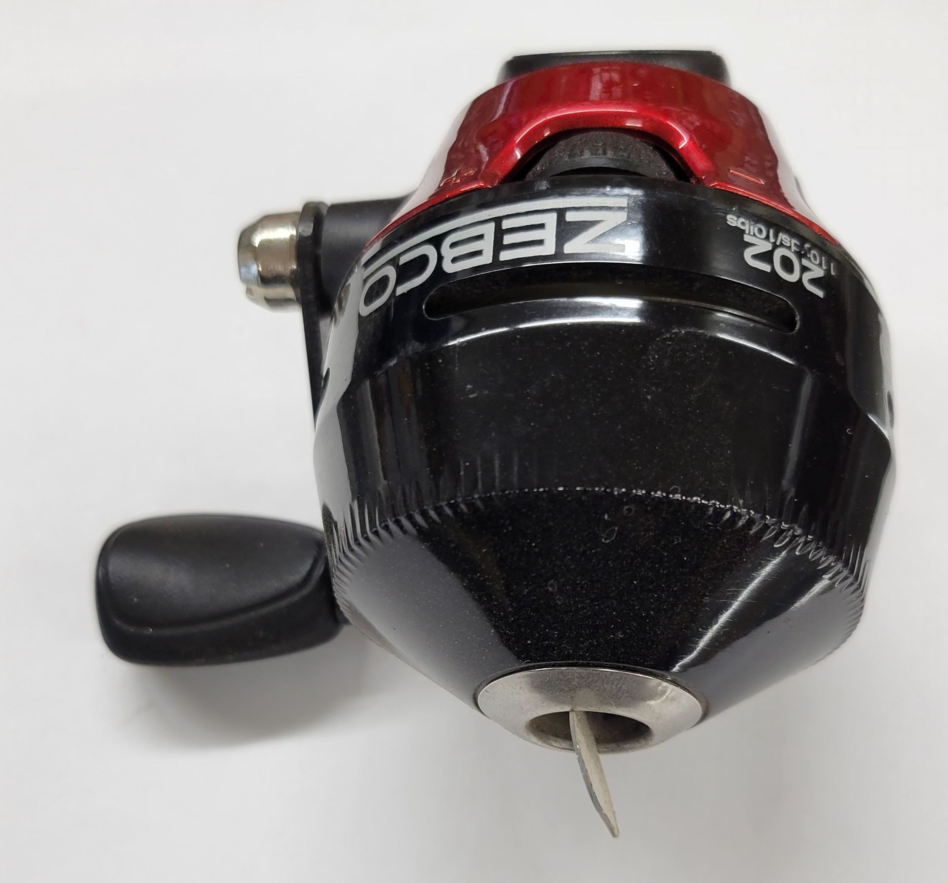 Black and red Zebco 202 fishing reel.