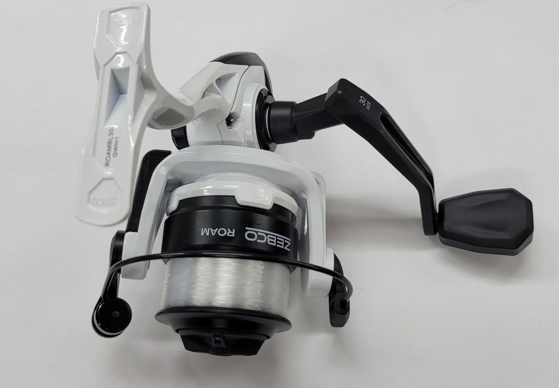 White and black fishing reel with the word ROAR.