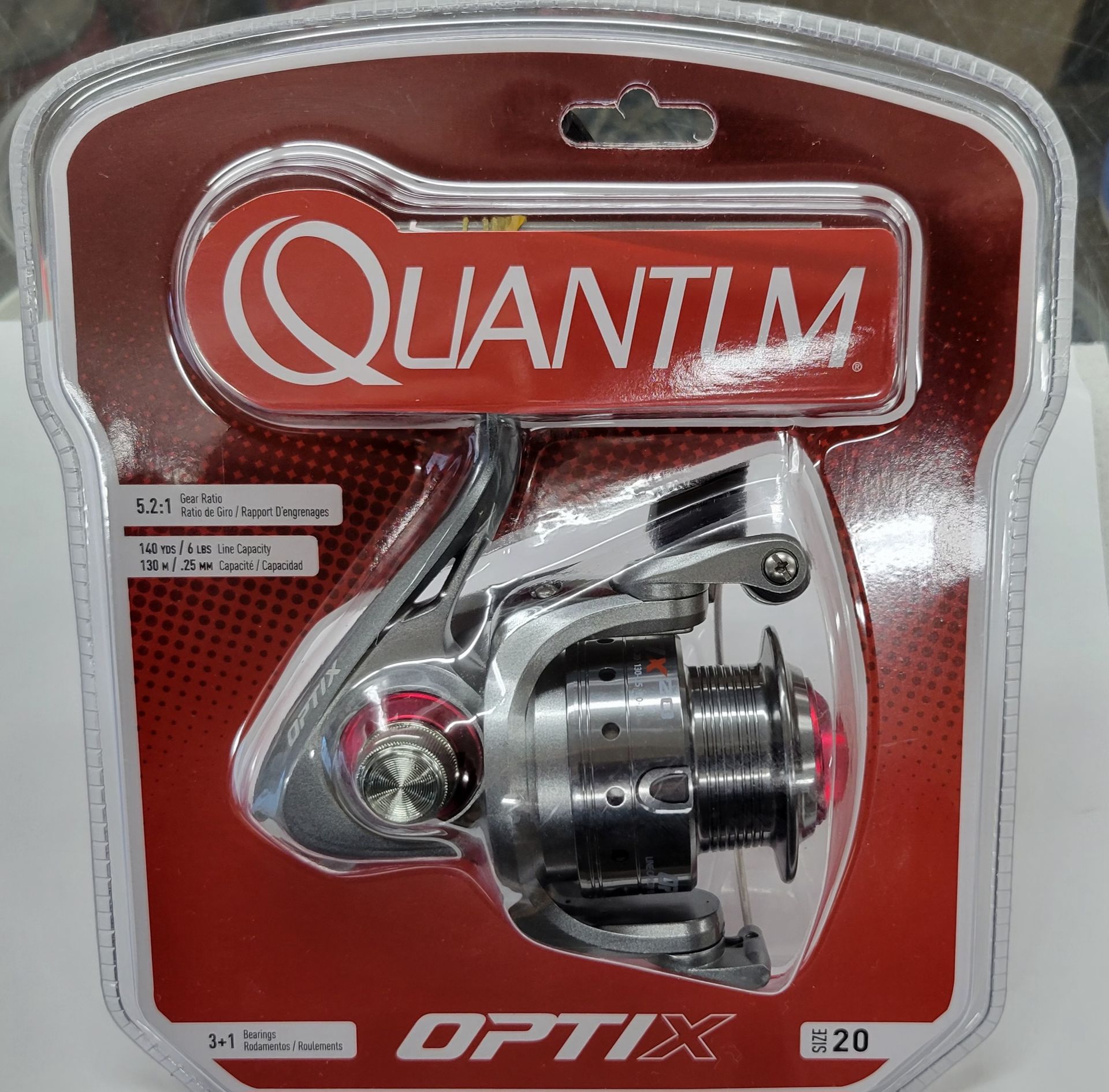Quantum Optix 20 fishing reel in packaging with red and white accents.