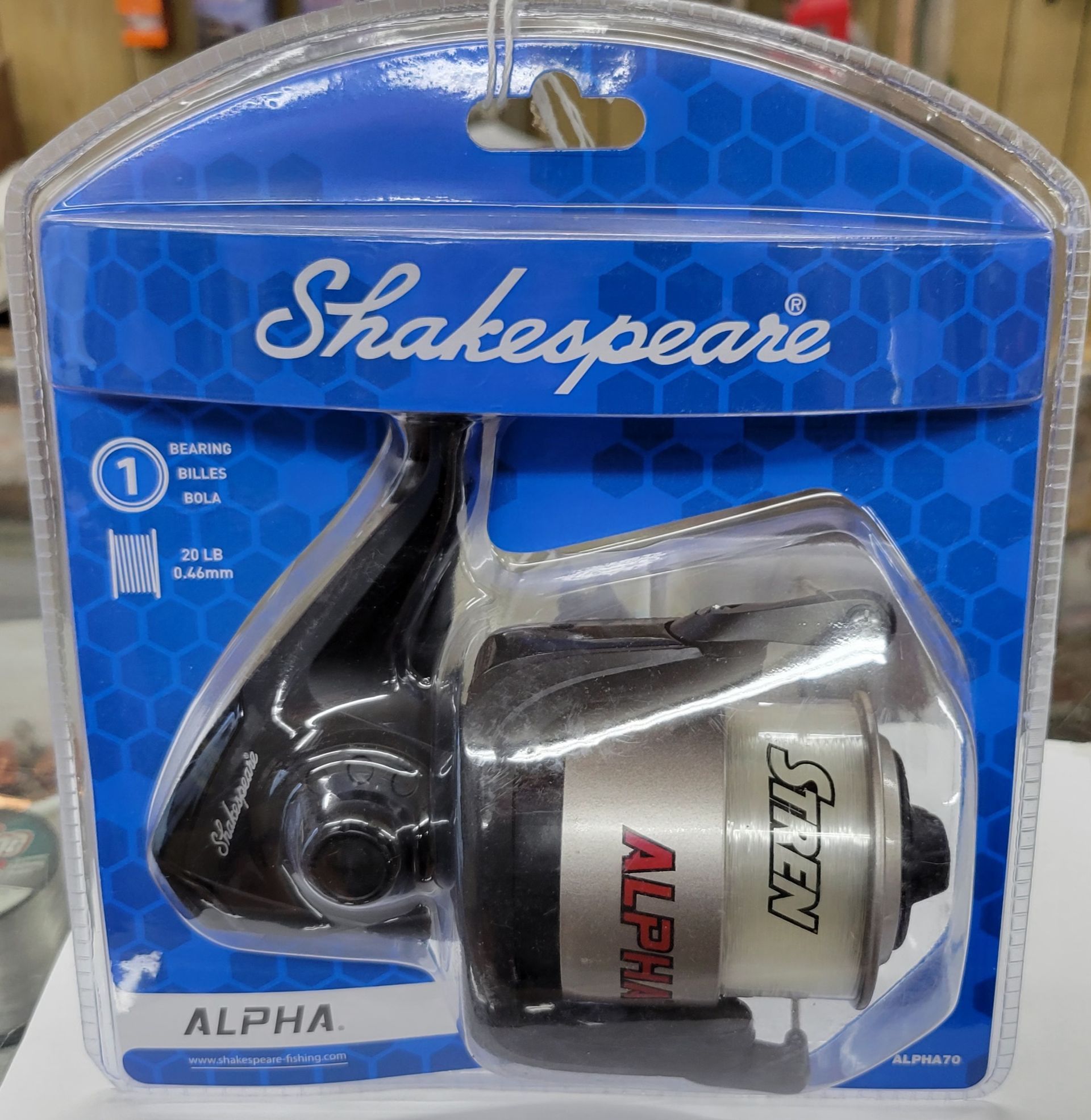 Shakespeare Alpha fishing reel in blue and clear packaging.