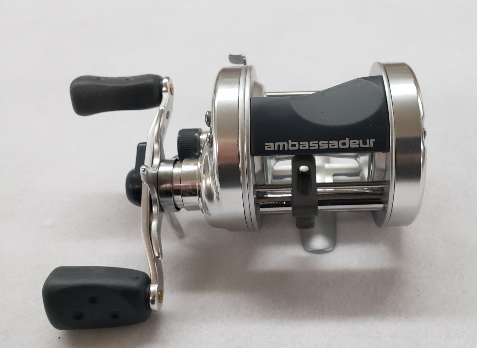 Silver and black Abu Garcia Ambassadeur fishing reel.