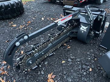 A machine with a chain attached to it is sitting on the ground.